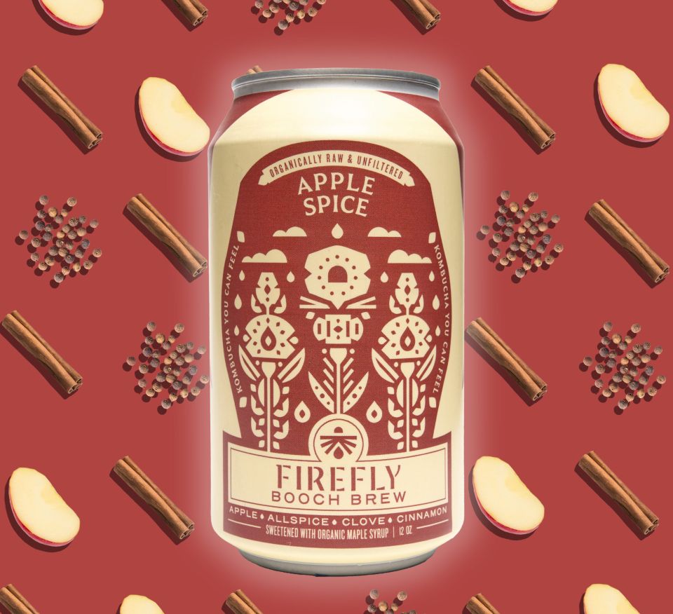 Firefly Brew Apple Spice kombucha can surrounded by ingredients.
