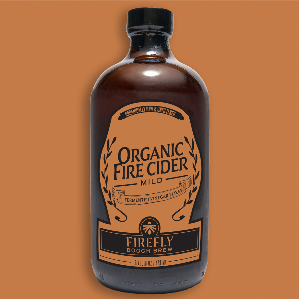 Bottle of Firefly Brew Organic Fire Cider on an orange background.
