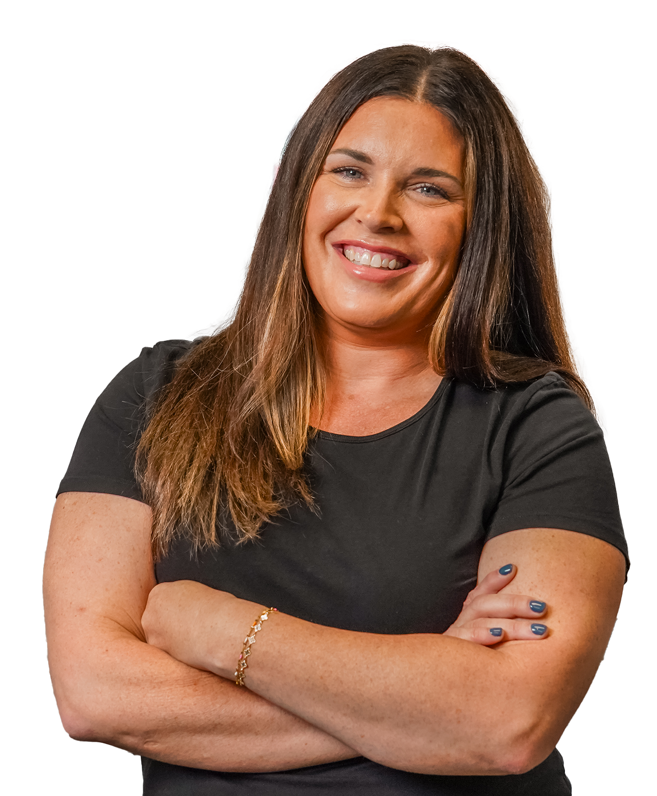 Smiling woman in a black shirt standing with arms crossed in a brewery.