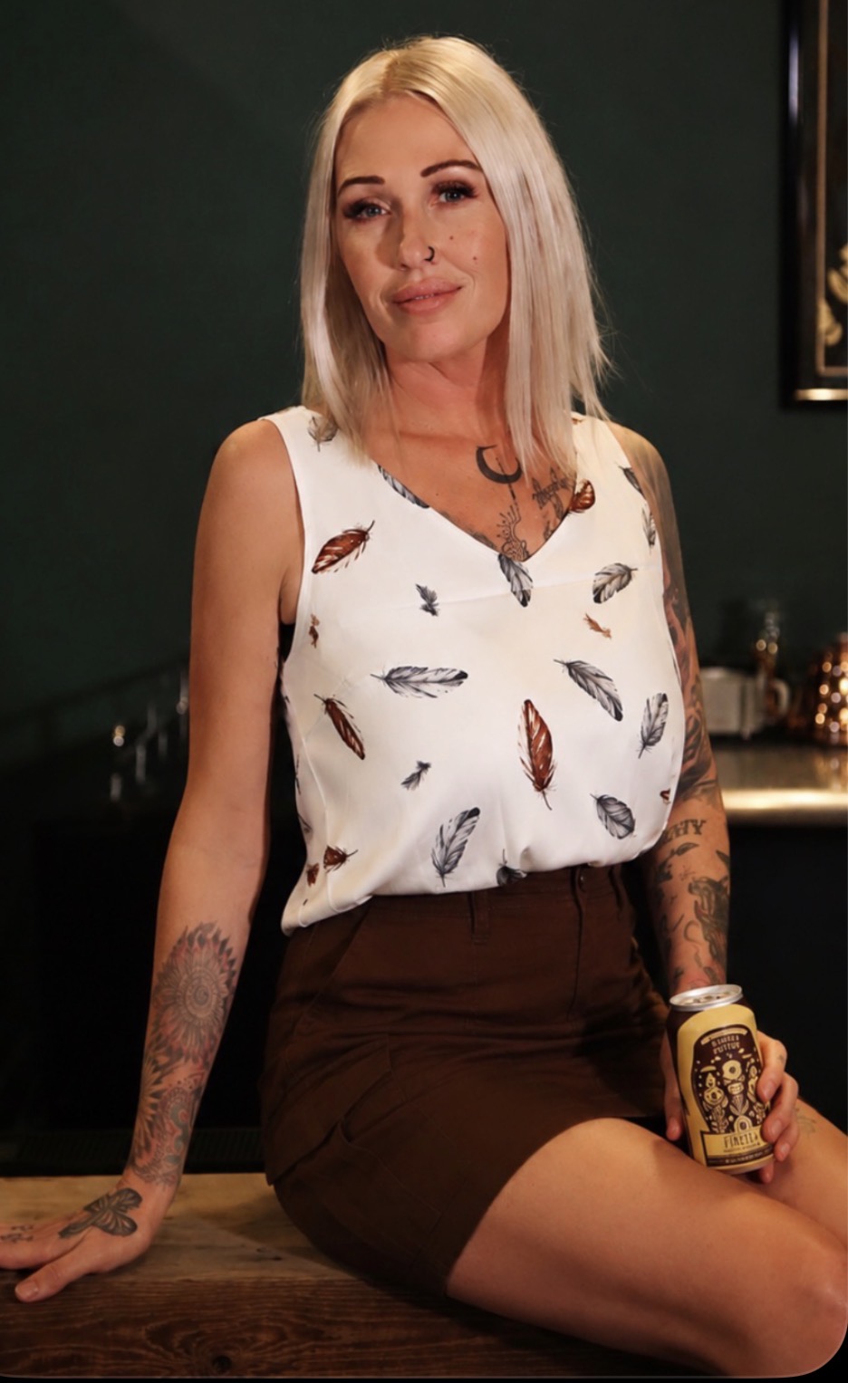 Kombucha brewer with tattoos and unique hairstyle at Firefly Brew in Oklahoma.